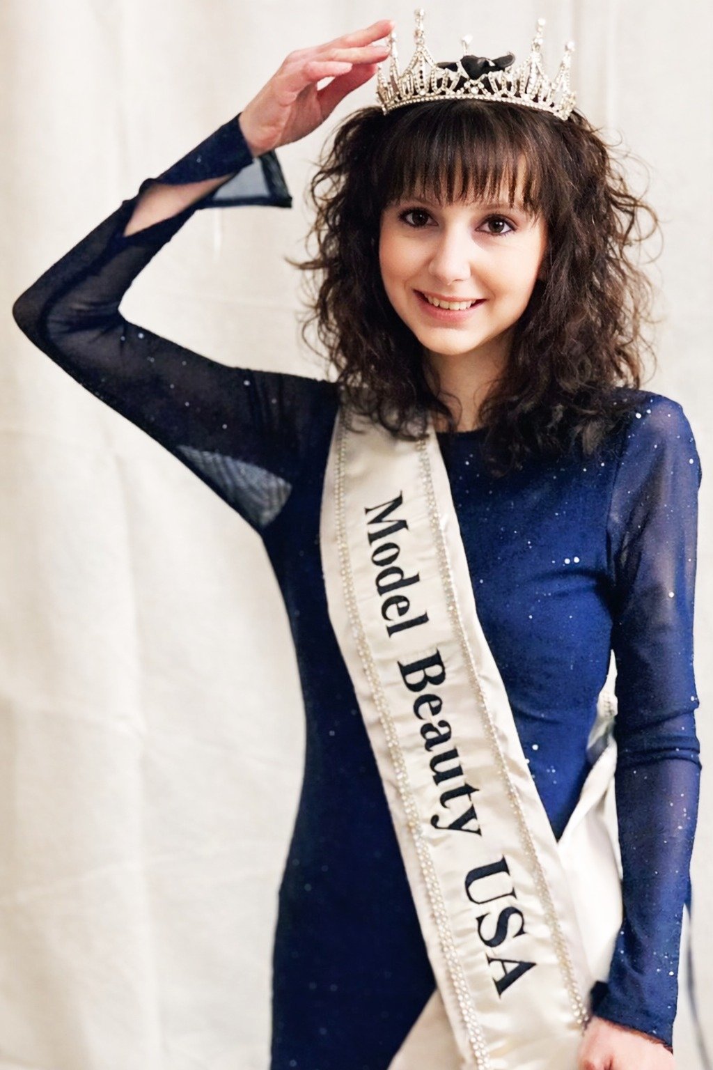 Model Beauty USA titleholder wearing crown and sash